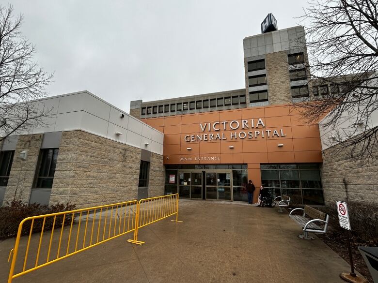 The exterior of a building with a sign reading Victoria General Hospital Main Entrance.