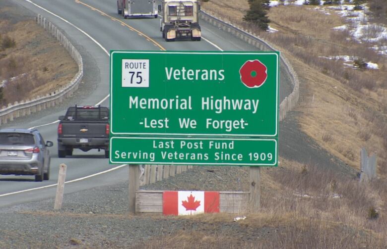 A large highway sign for the Veterans Memorial Highway. The sign includes a poppy and the phrase 