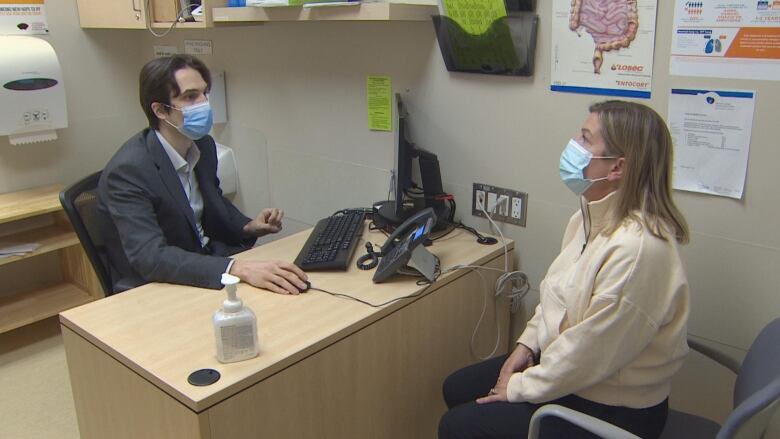 Doctor Daniel Marinescu and patient Farrell Eckman meet in an office at Vancouver General Hospital. 