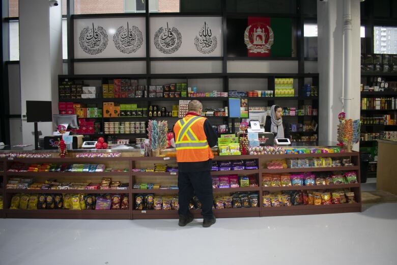 A man checking out at a counter.