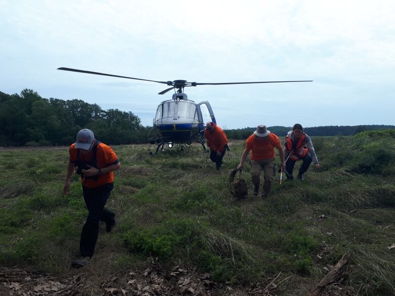 Search and rescue volunteers travel via helicopter to an inaccessible area during a search following the Nova Scotia flooding last summer near Windsor. 