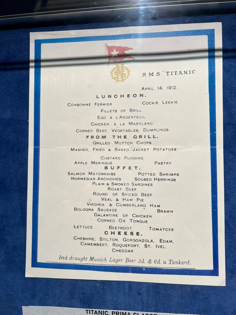 A menu is seen in front of a blue background.