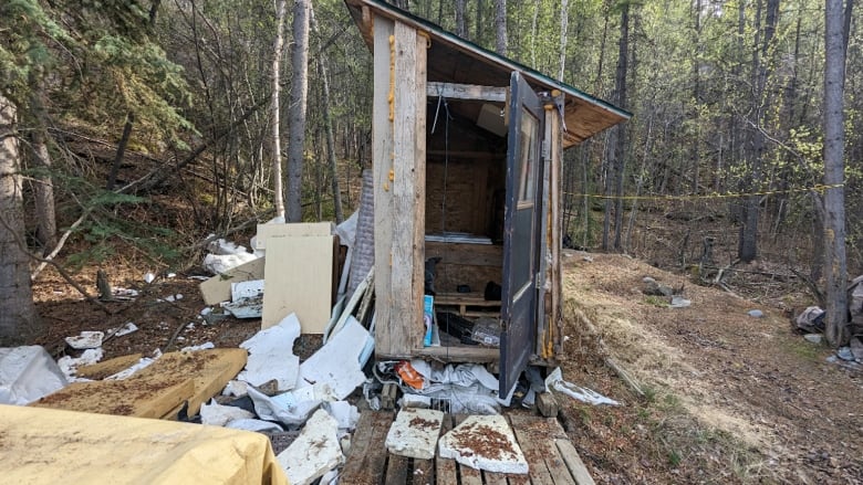 A toilet is surrounded by garbage.