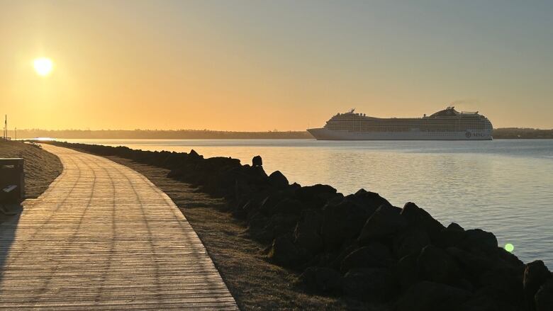 Cruise ship entering the harbour as sun rises.