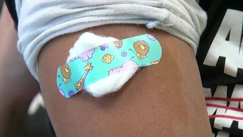 Close up of a colourful bandage on a child's arm