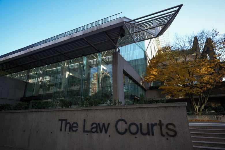 A glass and concrete building featuring the sign The Law Courts.