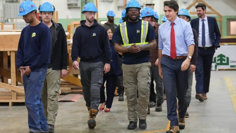 Prime Minister Justin Trudeau, right, meets with carpenters before speaking about new housing solutions at the CCAT training centre in Woodbridge, Ont., on Friday, April 12, 2024.