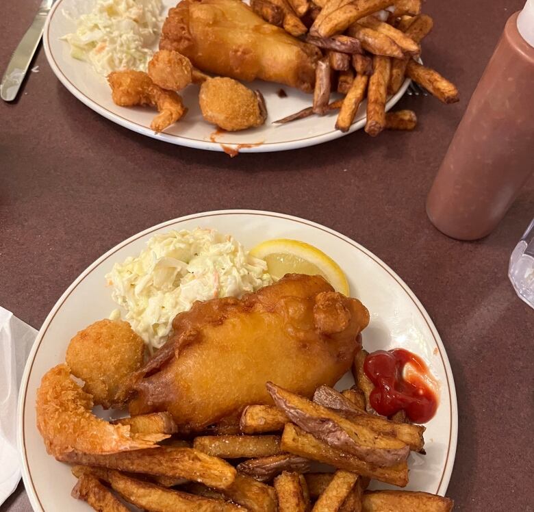 A plate of fish and chips sits on a red table. Gibson's Fish and Chips has been serving up the dish since 1964. 