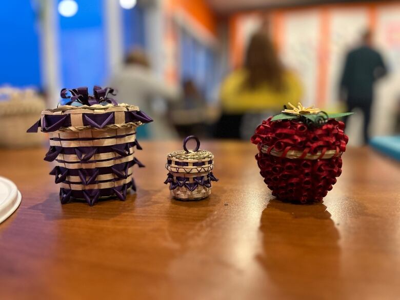 Three decorative fancy baskets lined in a row.