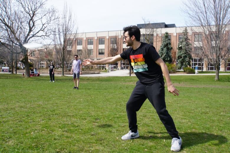 International student Arvin Nabaei passes the time by playing frisbee on campus after all his classes were suspended.