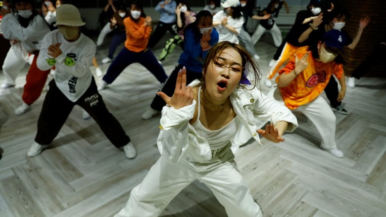 Japanese dancer ReiNa dances as she teaches dance moves to students.