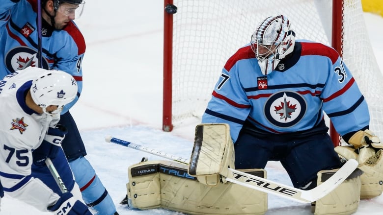 A goalie tries to make a save