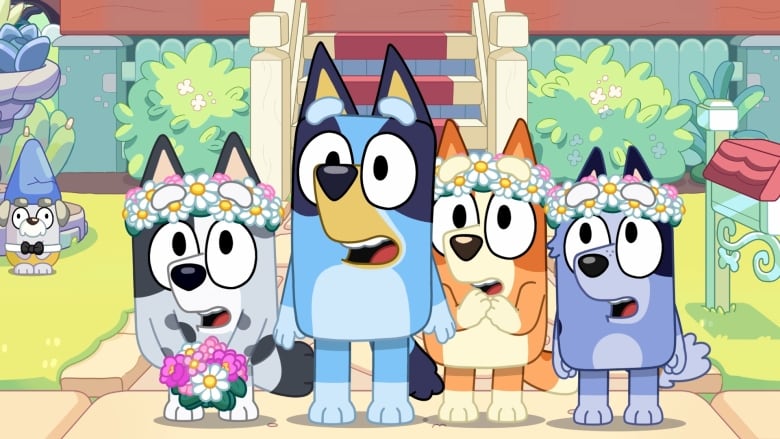 A cartoon image of four colourful dogs standing and  smiling