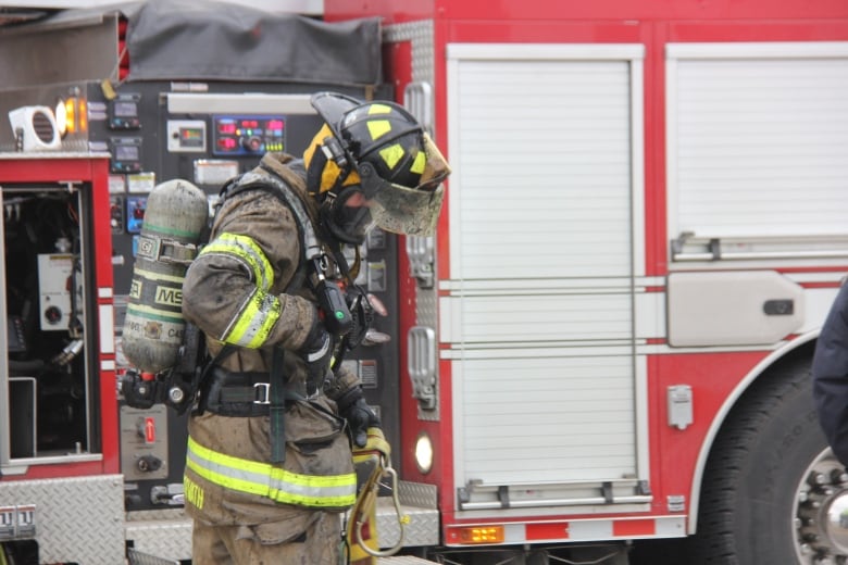 A Windsor firefighter is shown at the scene of a fire in the city.