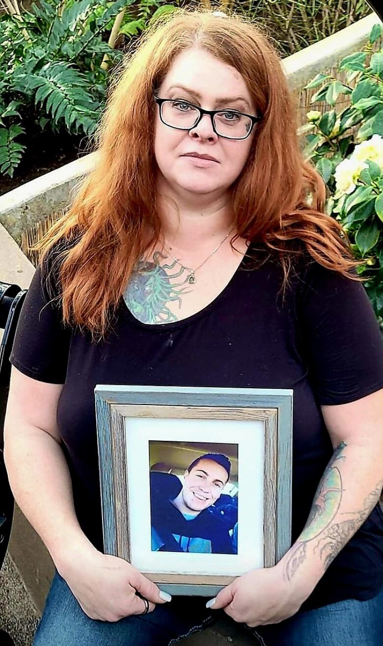 Tanya Hornbuckle holds a photo of her son Joel Wolstenholme, who fatally overdosed at his home in Edmonton in 2022.