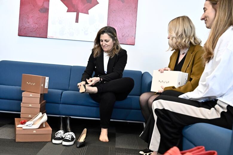 Deputy Prime Minister and Minister of Finance Chrystia Freeland tries on a pair of shoes from direct-to-consumer footwear company Maguire