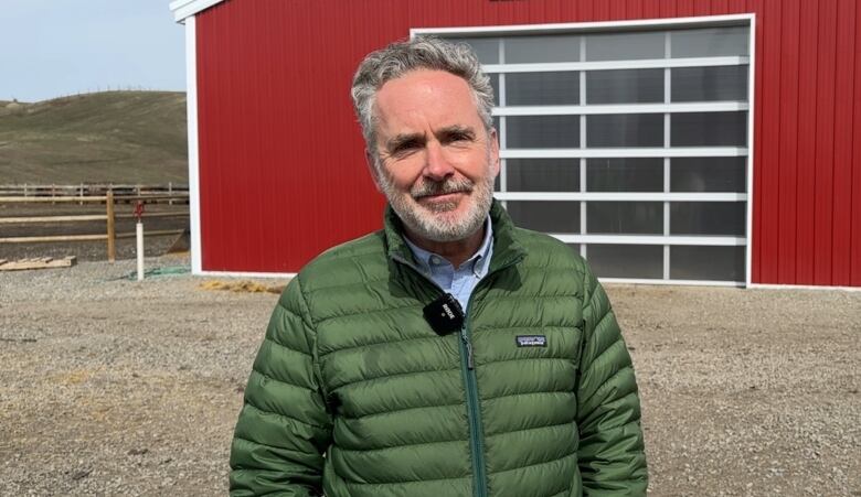 Jay Cross pictured outside a farm building.