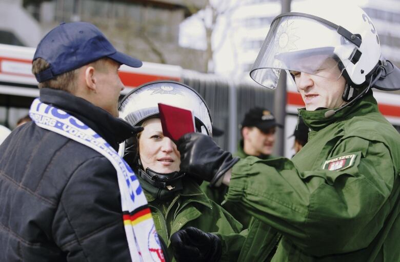 HAMBURG, GERMANY - MARCH 08:  Police officers simulate controlling a busload of rioting football fans during a security and police training exercise in preparation for the FIFA 2006 World Cup of March 8, 2006 in Hamburg, Germany. Hamburg will be one of the Host Cities during the FIFA 2006 World Cup in Germany.  (Photo by Elisenda Roig/Bongarts/Getty Images)