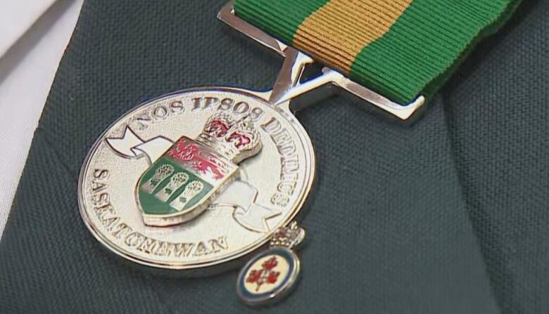 A close-up of a medal on a man's suit lapel.