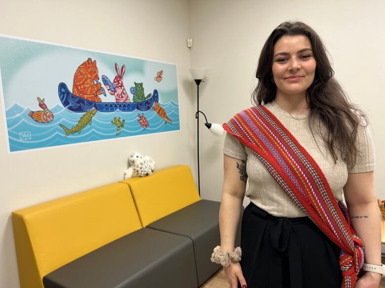 A woman wearing a Mtis sash stands in the waiting room of Native Montreal's family health clinic.