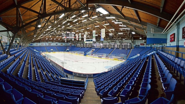 An ice rink with empty seats.