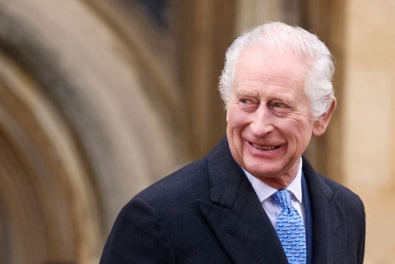 A person leaving a chapel looks off to the left.