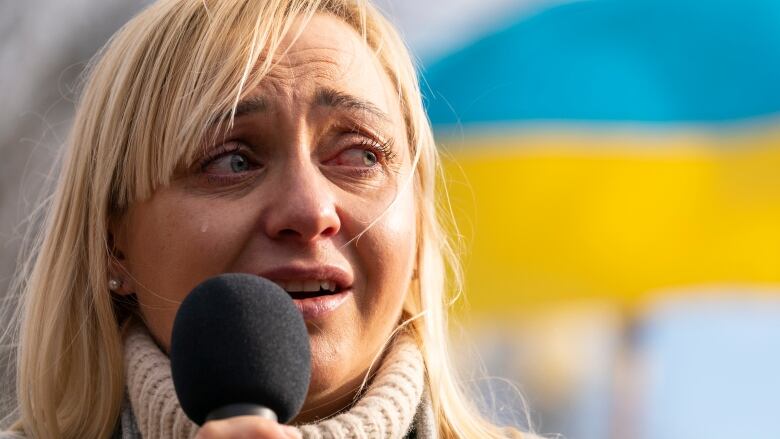 Ukrainian Parliament member Oleksandra Ustinova cries as she speaks during a protest against Russia's war on Ukraine in Lafayette Park near the White House on Sunday, March 13, 2022 in Washington.