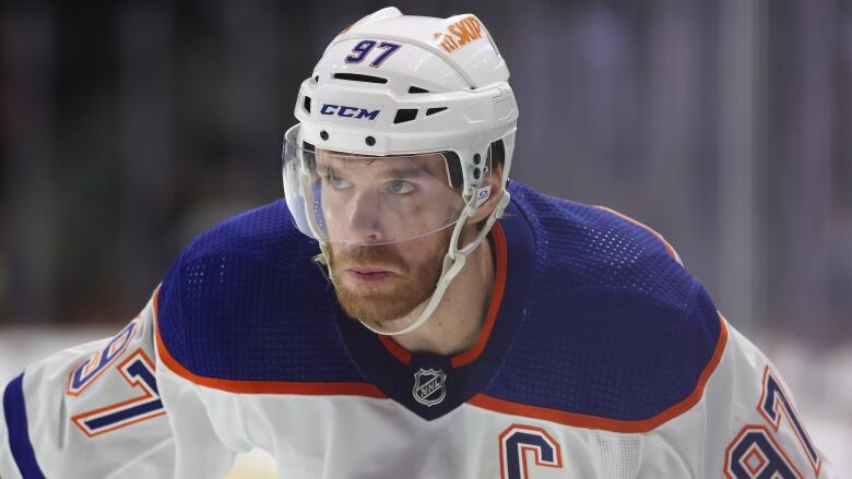 A men's hockey player looks on during a game.