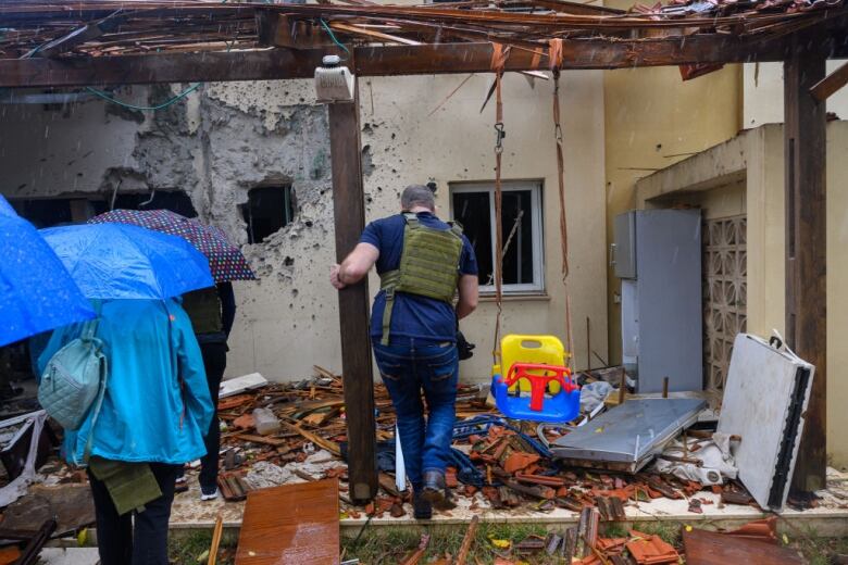 The exterior of a badly damaged house.