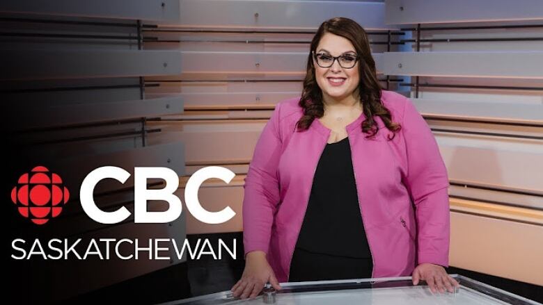 A woman in a pink blazer stands smiling behind a news desk. The CBC logo appears in red and white beside her on the bottom left.