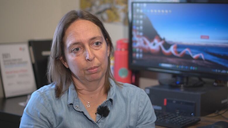 A support organization director gives an interview in an office.