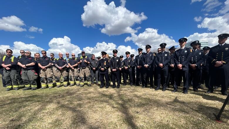 Rows of first responders are pictured standing outside.