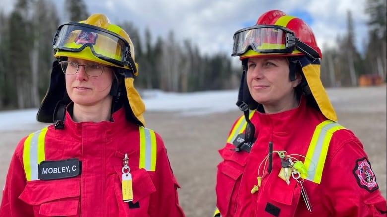 Two women in firefighting gear.