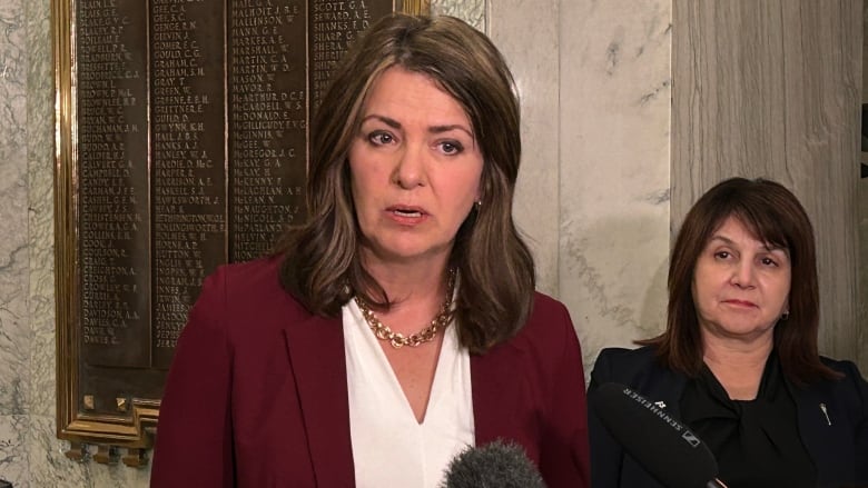 A woman speaks into a microphone.