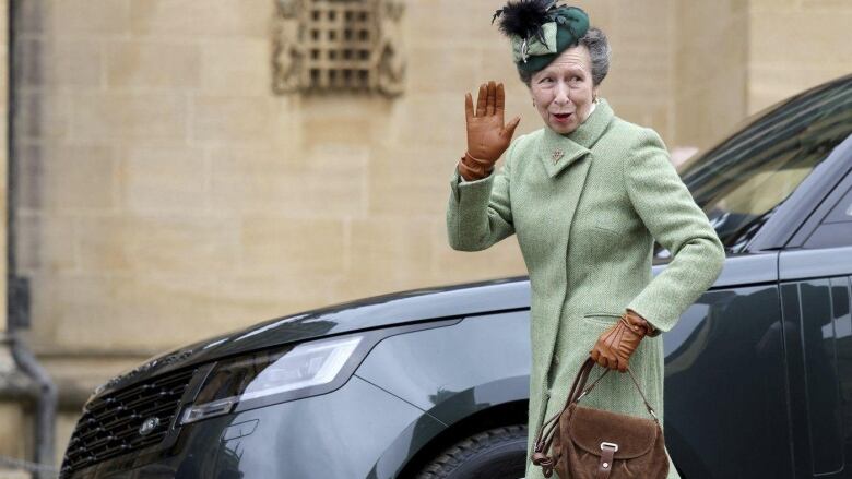 A woman waves.