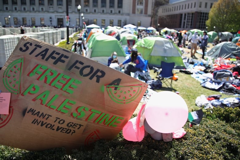 A cardboard protest sign bearing the words 