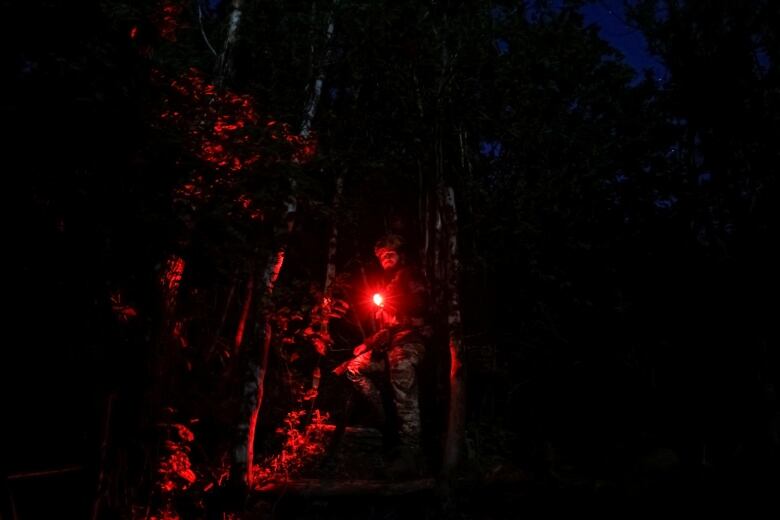 A Ukrainian soldier walks along a front-line position in the Donetsk region.