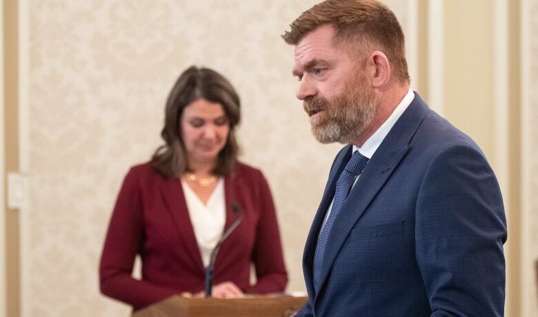 An Alberta politician swears on a bible while being sworn into office.