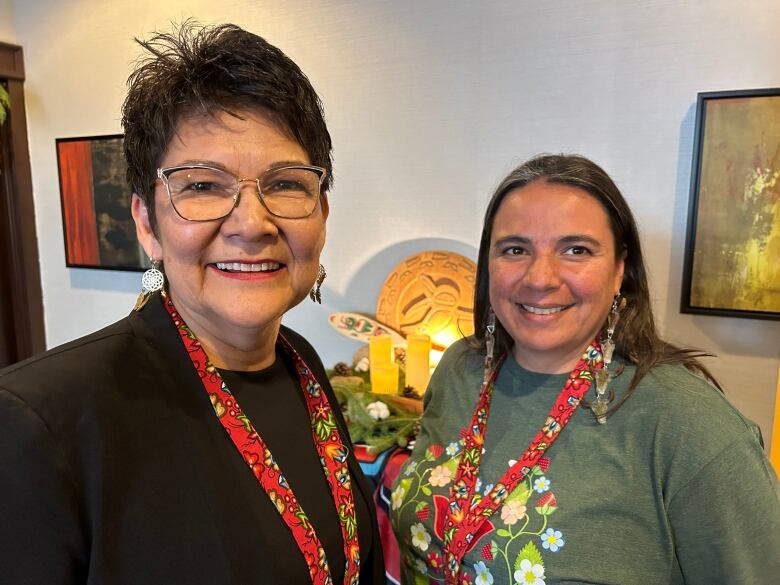 Two women smile for a photo.