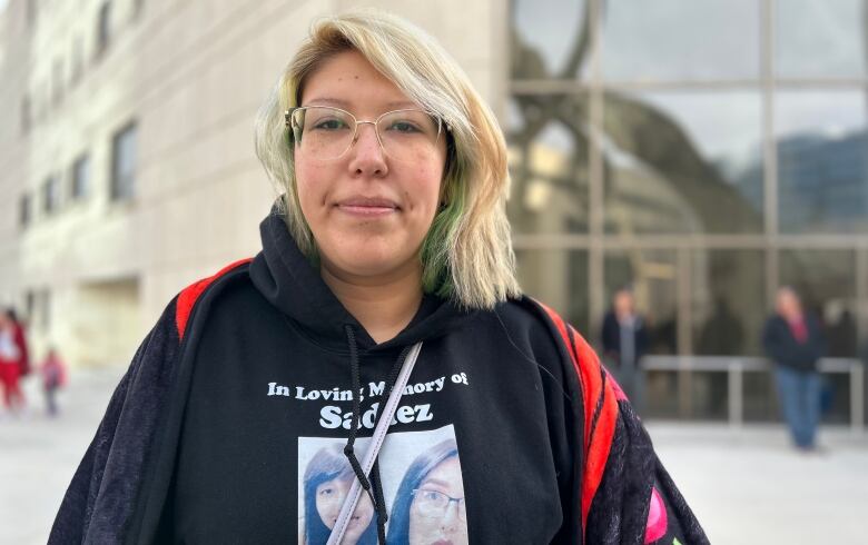 A woman wearing a shirt that says with the photograph of a woman. 