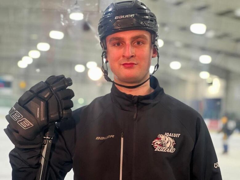 Iqaluit Blizzards coach Maxwell Joy holds hockey stick