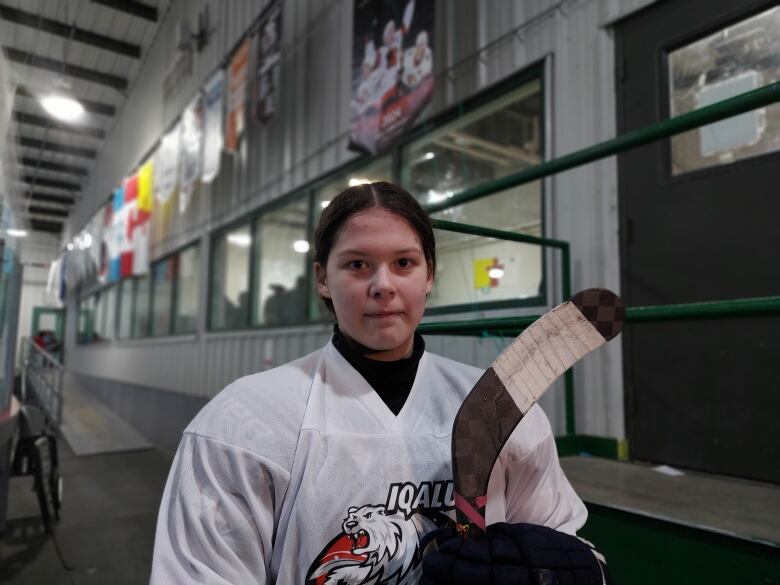 Iqaluit Blizzards defence Ayva-Lin Noah holds her hockey stick during a break from practice. 