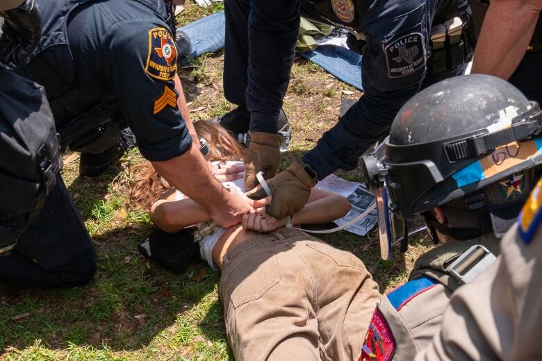 Texas State troopers and university police are seen arresting a pro-Palestinian protestor at the University of Texas at Austin.