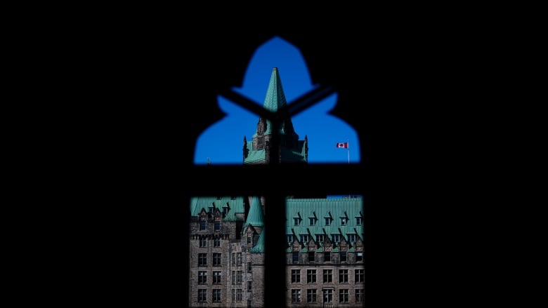 The Confederation Building is pictured through a window of West Block on Parliament Hill in Ottawa on Tuesday, April 16, 2024. 