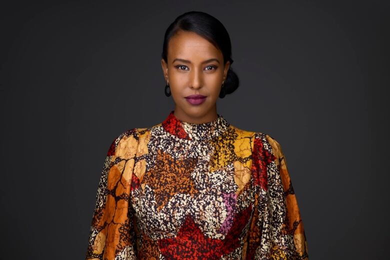 Woman in traditional african outfit gazes at camera 