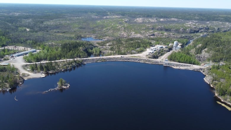 An aerial view of a lake and a hydro dam, in summer.