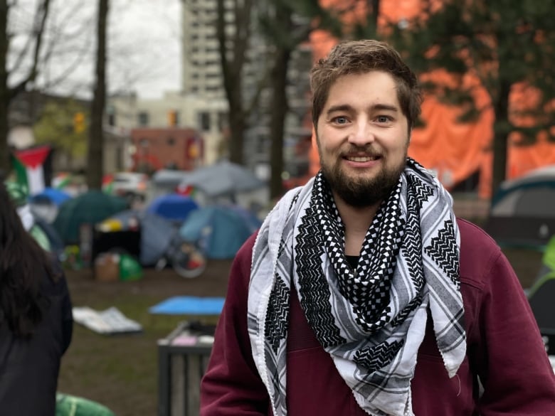 A man with a black and white scarf.