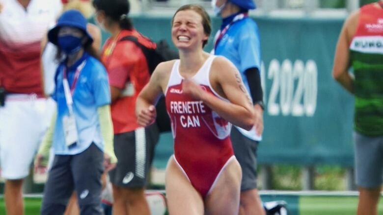 Canadian Para triathlete Kamylle Frenette reacts to crossing the finish line.