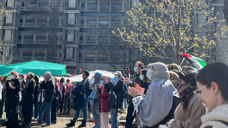 A group of people chanting and clapping 