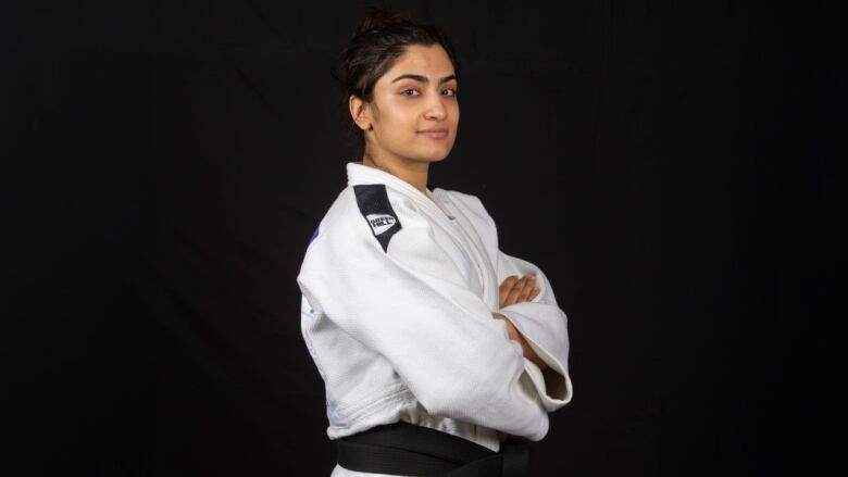 A woman judoka poses.